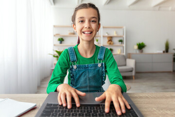 Poster - Doing Homework. Portrait of smiling student using laptop, studying online at home, happy girl typing on keyboard looking at pc screen, chatting with friends or making school research, web camera pov