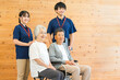 © buritora - 介護施設にいるシニア男女と言語聴覚士・理学療法士の男性（認知症・リハビリ）