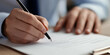 © Andres Mejia - Signing important business document with pen in hand