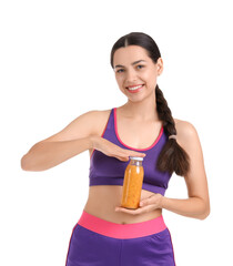 Wall Mural - Sporty young woman with healthy smoothie on white background