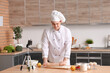 © Pixel-Shot - Male chef with dough and fruits recording cooking video in kitchen