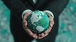 © Wanida - Hands Holding a Textured Globe Surrounded by Green Elements Representing Environmental Awareness and Sustainability