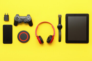 Wall Mural - set of modern devices on yellow background, top view
