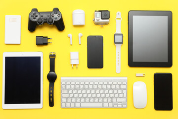 Wall Mural - set of modern devices on yellow background, top view