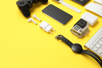 Wall Mural - many modern devices on yellow background