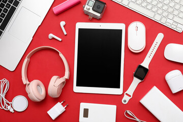 Wall Mural - set of modern devices on red background, top view