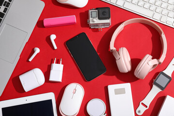 Wall Mural - set of modern devices on red background, top view