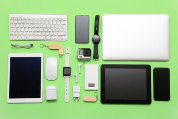 Wall Mural - set of modern devices on green background, top view