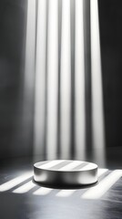 Wall Mural - A podium with a sleek silver finish, positioned in front of an empty space with soft beams of light shining down