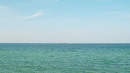 Wall Mural - View of calm sea with artificial concrete structure. Empty sea on summer day. Ocean view background.