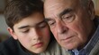 © yusufadi - A poignant moment captured: Grandson comforting his Grandfather. A tender display of affection between generations, revealing a deep bond of love and support.