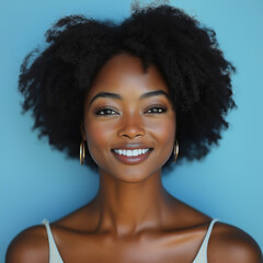 Wall Mural - Beauty african american woman with clean healthy skin on beige background. Smiling dreamy beautiful afro haitstyle girlon on blue background