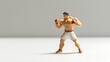 © Christ - Boxer action figure in fighting pose minimalist toy photography studio
