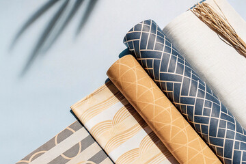 Poster - Rolled patterned paper sheets with geometric designs.