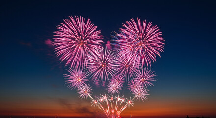 fireworks display in the night sky with vibrant colors and patterns exploding above a horizon