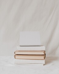 Poster - Minimalist Workspace Elegance Open Laptop on Linen-Covered Books - Digital Language Exams and Professional Certification Prep for Modern Knowledge Workers