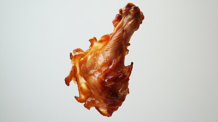 Wall Mural - 83.A dynamic image of a grilled chicken leg suspended in mid-air, its crispy skin and charred edges clearly visible, set against a stark white background to highlight its vibrant color.