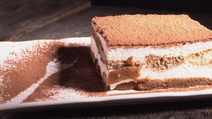 Wall Mural - Tiramisu cake dessert served with coffee, biscuit and cocoa on dark background.spoon. Dessert. Food Concept