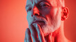 © Cheetose - thoughtful older man with beard in red light, expressing contemplation