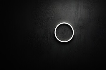 Wall Mural - Minimalist circular light fixture on a textured black wall, creating a modern ambiance