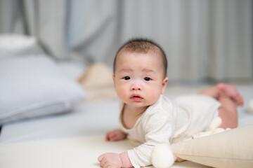 Wall Mural - Newborn baby crawling on mat in living room