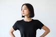 © Tengkwa - Confident Woman in Black T-shirt: A young Asian woman with short black hair, exudes confidence and poise. She stands with her hands on her hips.