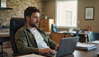 © Elena - Labor Day. Software developer coding with focus in an office cubicle at late night with coffee cup nearby
