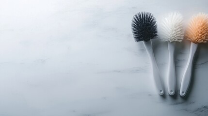 Poster - Three white and black brushes are on a marble countertop