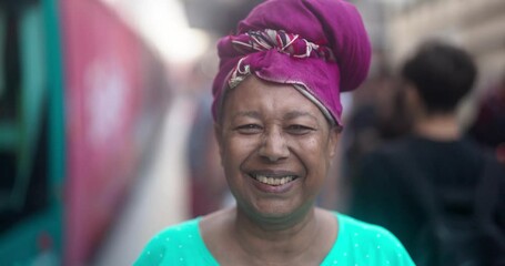 Wall Mural - Happy african senior woman smiling on camera at tram station in the city wearing traditional clothes - Elderly person, culture and lifestyle concept 