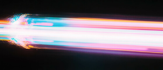 Aufkleber - Bright light trails create dynamic spark effects on a black background