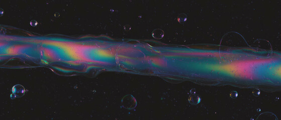 Poster - Vibrant rainbow bubbles on a black background create an artistic effect