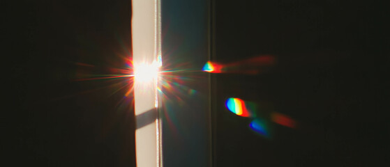 Poster - Light leaks through a window, creating atmospheric effects and lens flares on a dark background