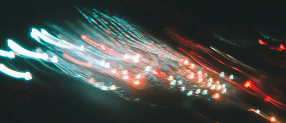 Poster - Streaks of vibrant light trails create a dynamic and modern texture against a dark background