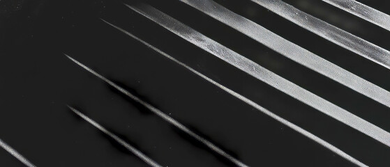 Poster - Lines create shadowed texture on a black background for striking visual appeal