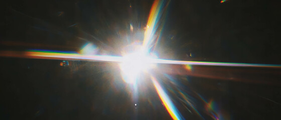 Poster - Vintage lens flare effect overlay with space for logo on a black background