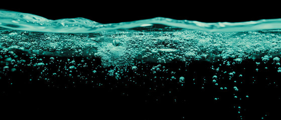 Poster - Water bubbles creating a submerged effect against a deep black background for an aquatic feel