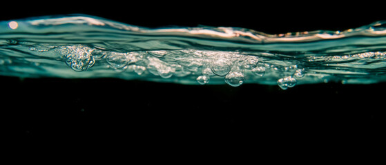 Poster - Bubbles rising in deep water with a submerged effect against a black background
