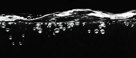 Poster - Bubbles underwater in deep water with submerged effect against a black background