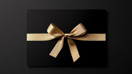 Wall Mural - Elegant black gift card with golden ribbon bow, offering a touch of luxury and sophistication