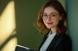 © Hunman - Smiling brunette business woman in eye wear glasses, spectacles with folder.