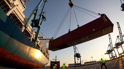 Poster - Dockworkers orchestrate container loading onto a cargo ship, showcasing the complex operations of a bustling commercial port during a vibrant sunset
