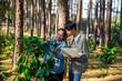 © doidam10 - Harvest coffee bean ripe Red berries typing laptop computer check quality control plant coffee tree. Smart farmer using laptop in green coffee farm sustainable quality control agriculture technology