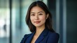 © The 2R Artificiality - Professional portrait of a confident businesswoman in a suit with crossed arms and a modern office background Copy Space
