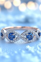 Poster - Elegant rose gold ring with blue sapphires and diamonds on a light blue textured background