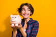 © deagreez - Photo of toothy beaming woman with bob hairdo dressed plaid shirt hold money box look empty space isolated on yellow color background