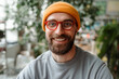 © Maria Vitkovska - Portrait of smiling bearded man wearing glasses and yellow beanie looking at camera