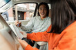 © Maria Vitkovska - Driving instructor explaining lesson to student inside car