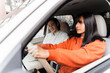 © Maria Vitkovska - Young woman driving car with instructor next to her