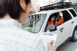 © Maria Vitkovska - Young woman waving from car window greeting driving instructor