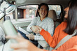 © Maria Vitkovska - Driving instructor shaking hands with student after successful driving test